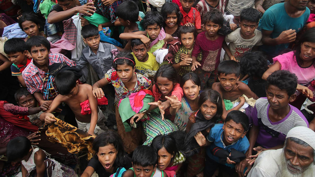 Rohingya children scramble for relief materials at Balukhali camp, Ukhia, on Wednesday. Photo: Abdus Salam