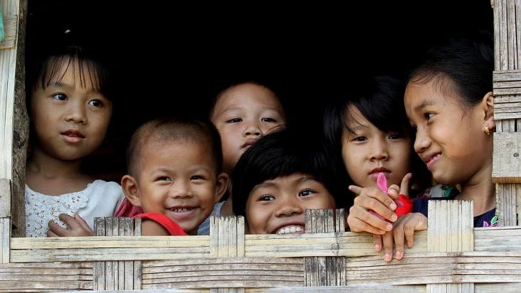 A group of ethnic children seen staring through the window of a Machan Bari (house made on a bamboo platform). The picture was taken from Natunpara, a village of Rangamati, by Supriyo Chakma.