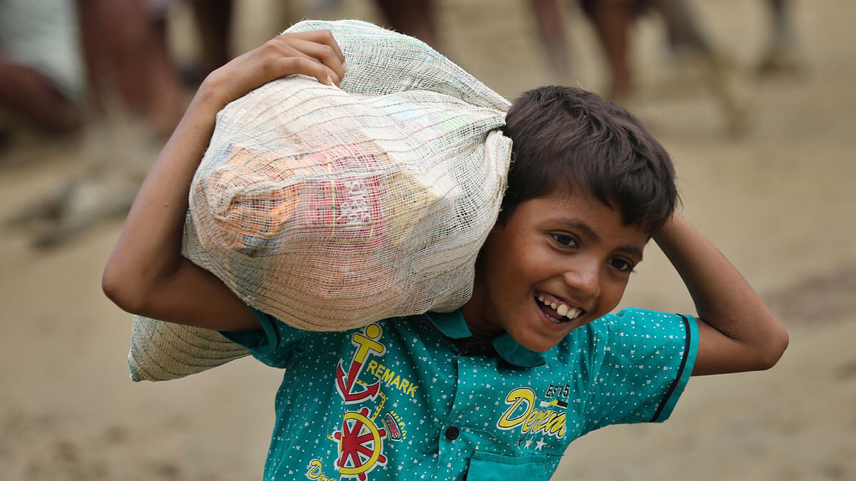 The Rohingya boy looks happy after collecting the relief at Balukhali area of Cox’s Bazar on Sunday. Photo: Sourav Das
