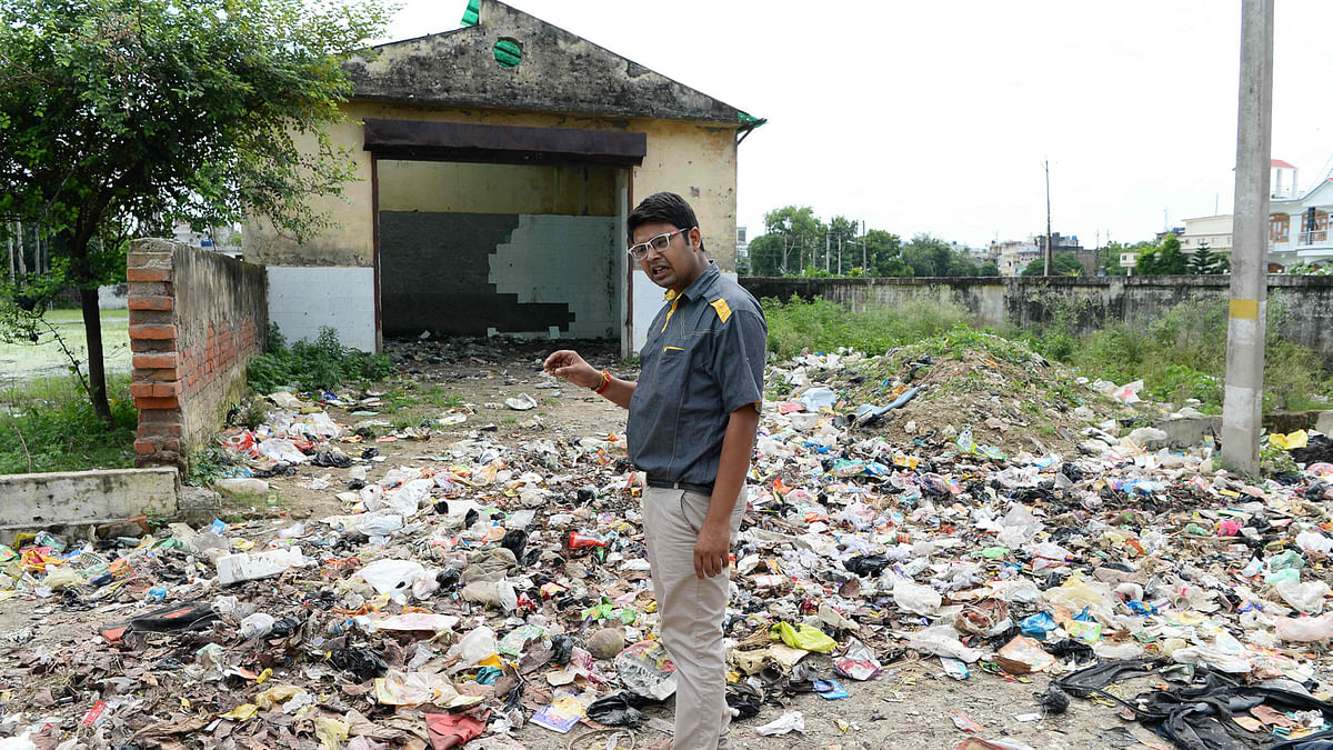 In this photograph taken on 20 August, 2017, Durgesh Mishra stands near a dumpsite as he speaks during an interview with an AFP reporter in Gonda district, in the Indian state of Uttar Pradesh. Photo: AFP