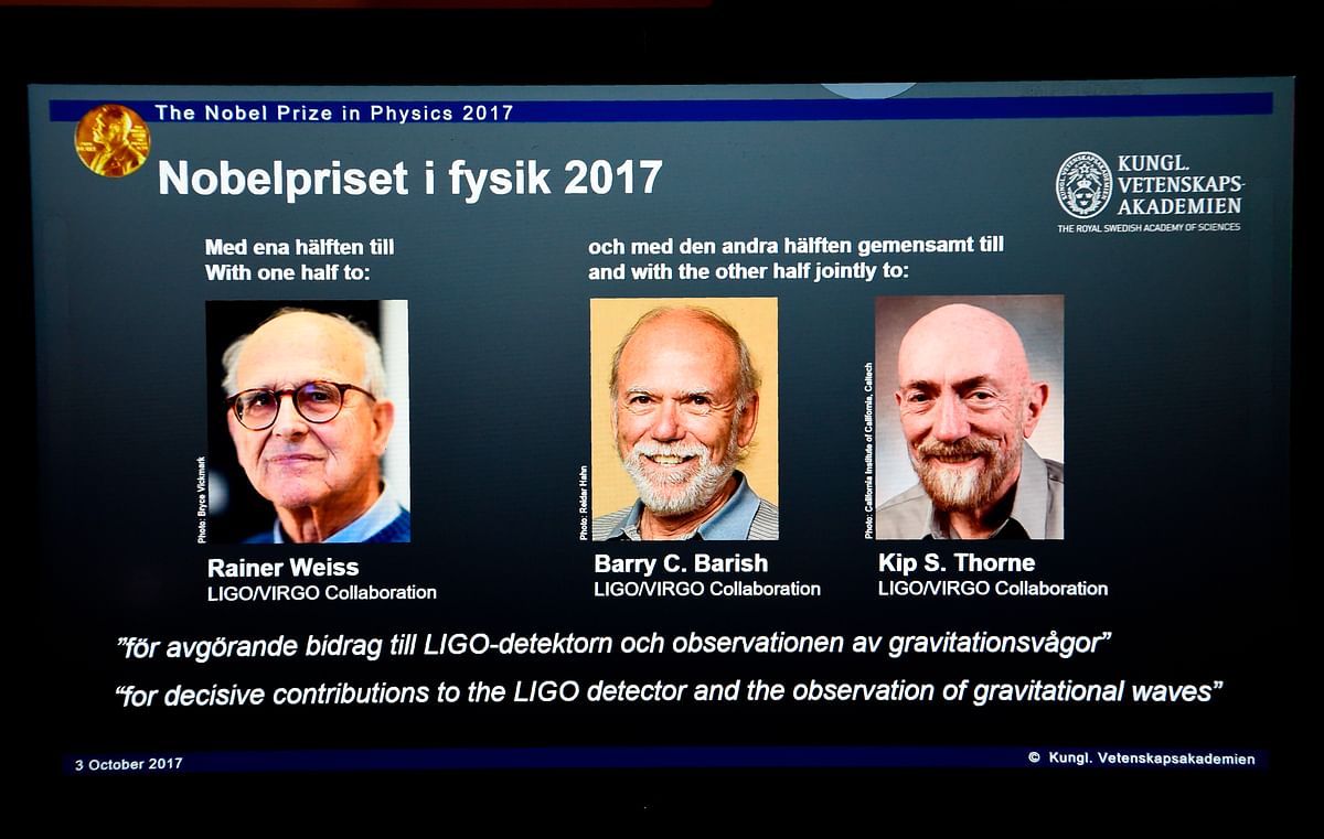 Laureates (L-R) Rainer Weiss, Barry C Barish and Kip S Thorne are pictured on a display during the announcement of the 2017 Nobel Prize winners in Physics on October 3, 2017, at the Royal Swedish Academy of Sciences in Stockholm. AFP