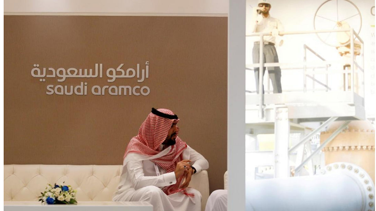 Reuters file photo: A Saudi Aramco employee sits in the area of its stand at the Middle East Petrotech 2016, an exhibition and conference for the refining and petrochemical industries, in Manama, Bahrain, on 27 September 2016.
