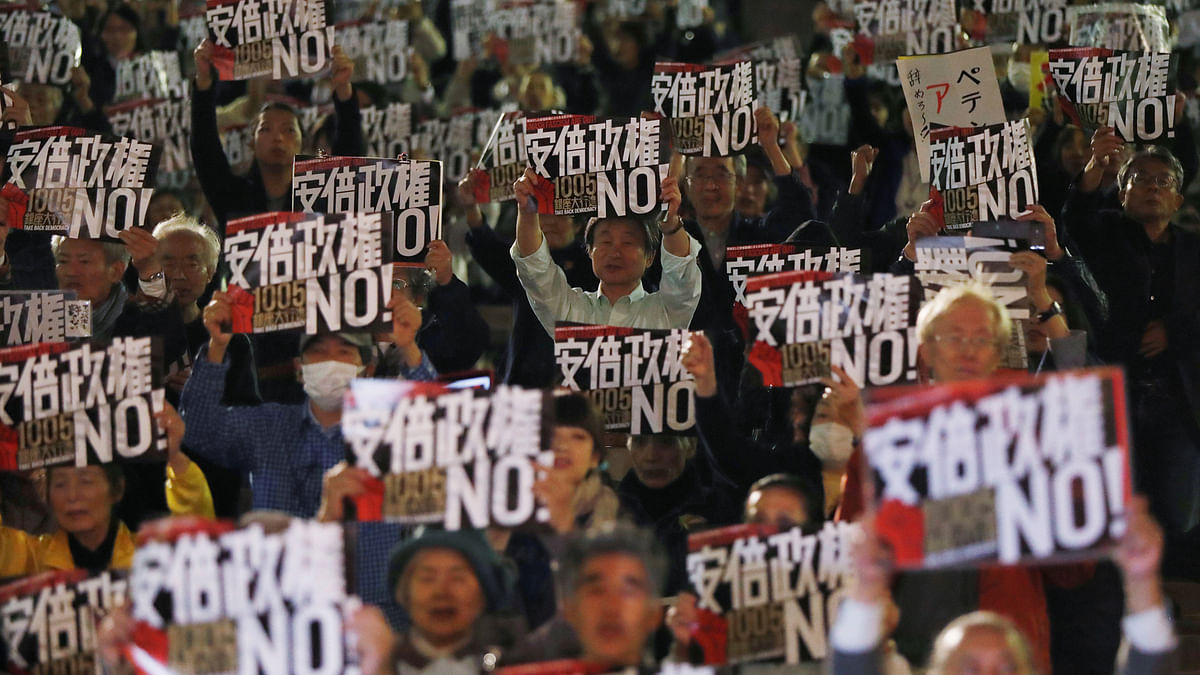 People hold placards denouncing Japan`s prime minister Shinzo Abe`s administration during an anti-government rally in Tokyo, Japan on 5 October 2017. Photo: Reuters