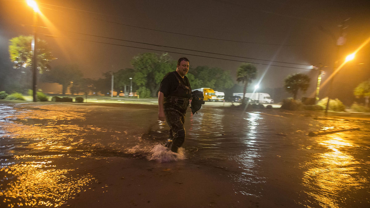 Lanny Dean, from Tulsa, Oklahoma, takes video as he wades along a flooded Beach Boulevard next to Harrahs Casino as the eye of Hurricane Nate pushes ashore in Biloxi, Mississippi on 8 October, 2017. Photo: AFP