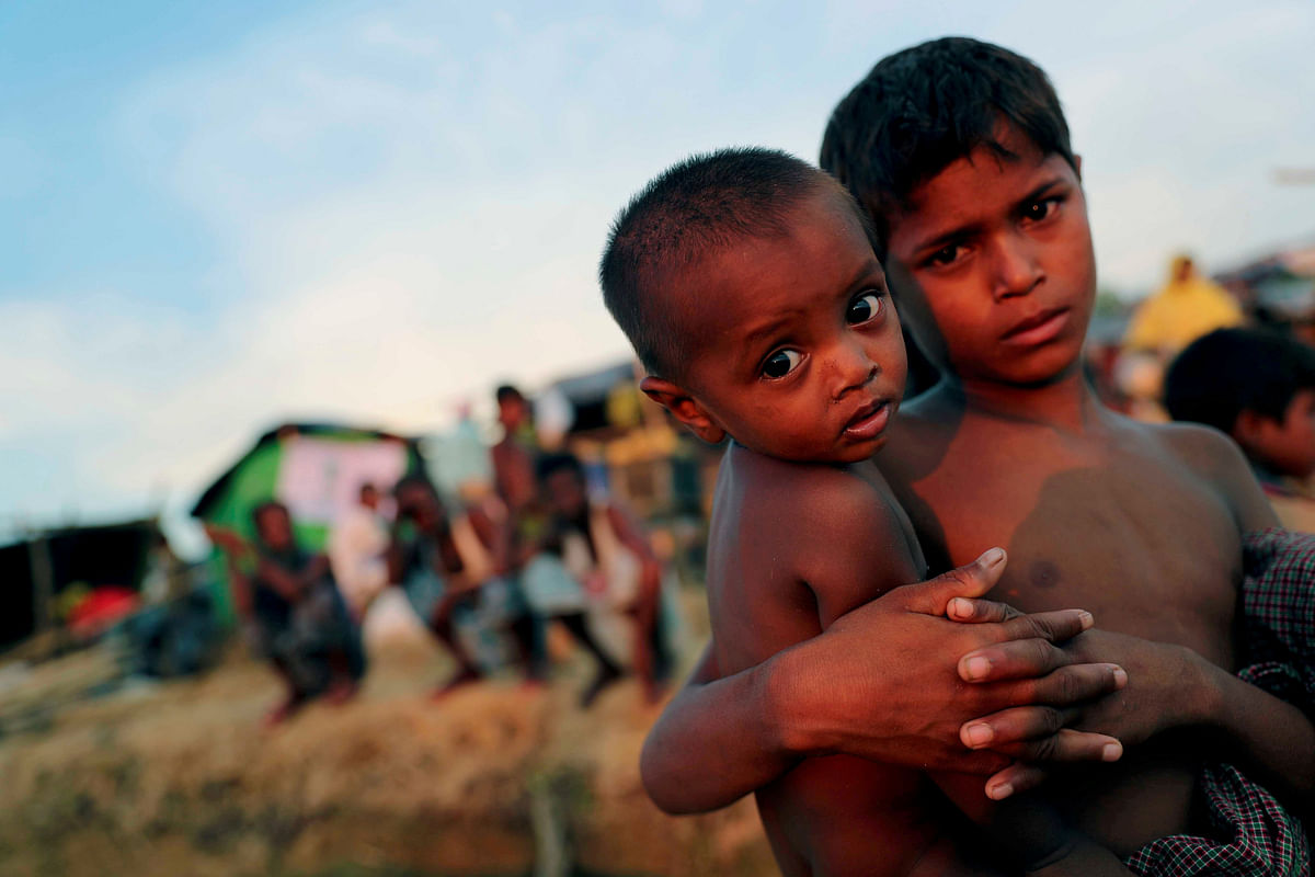 Cap: Rohingya refugee children look on at a refugee camp in Palang Khali near Cox's Bazar, Bangladesh, 4 October 2017. Photo: Reuters