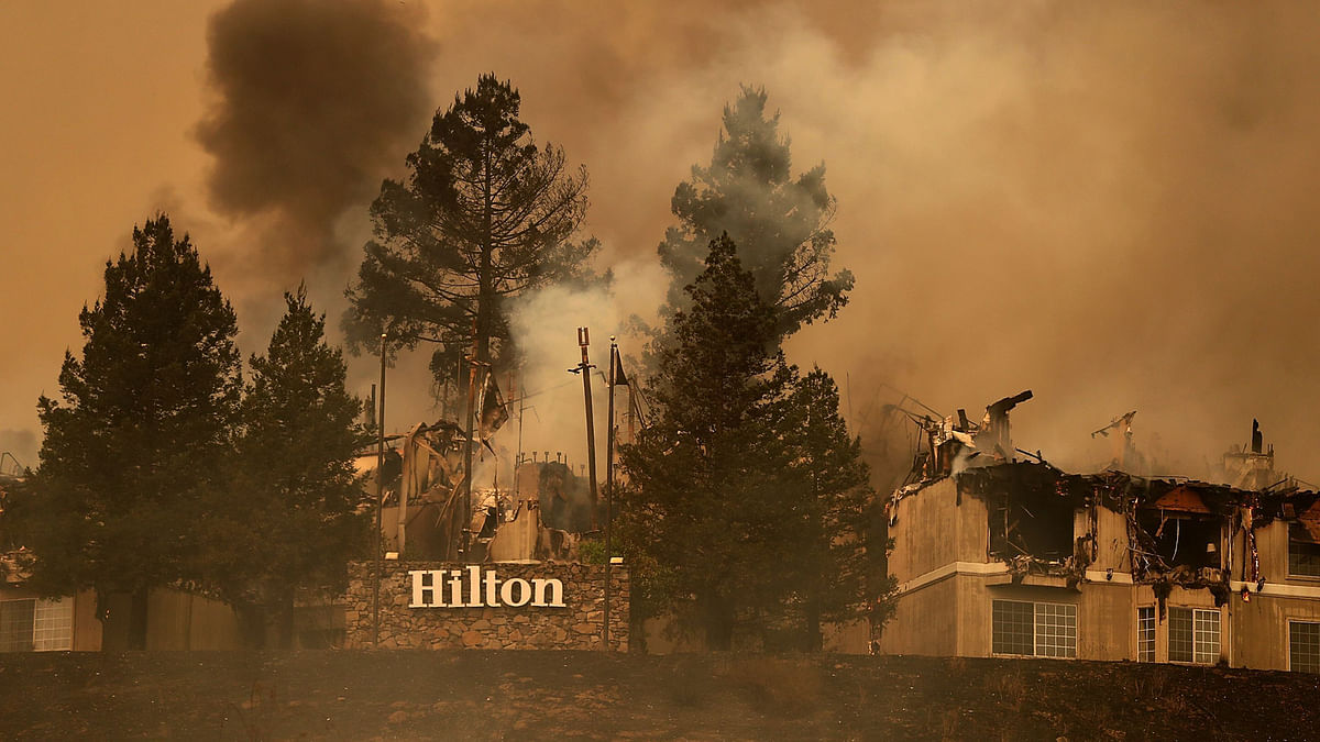 Smoke continues to rise from the Hilton Sonoma Wine Country on October 9, 2017 in Santa Rosa, California. Ten people have died in wildfires that have burned tens of thousands of acres and destroyed over 1,500 homes and businesses in several Northen California counties. AFP