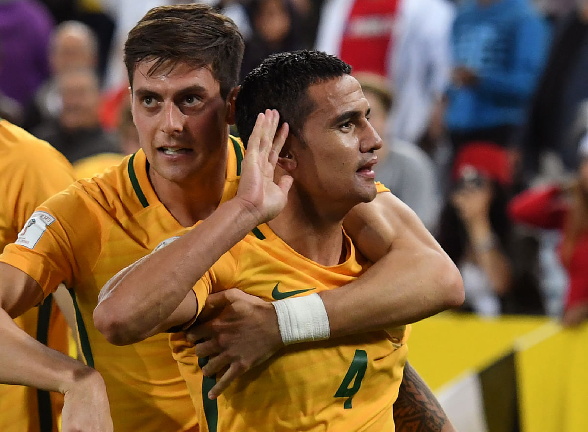 Tim Cahill of Australia (C) celebrates with teammate Tomi Juric (L) after scoring the winning goal against Syria during their 2018 World Cup football qualifying match in Sydney on Tuesday. AFP