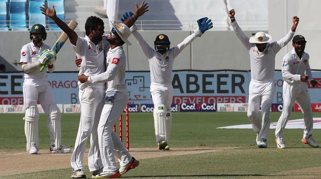 Sri Lanka players celebrate the dismissal of Muhammad Amir (C) of Pakistan during the second Test at Dubai International Cricket Ground in Dubai on Tuesday. AFP