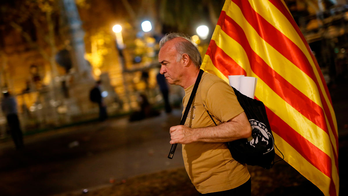 A man walks with the Catalan flag in Barcelona on Tuesday. AFP