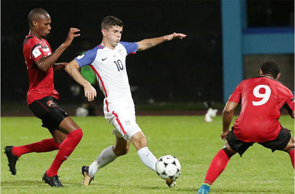 United States` Christian Pulisic and Trinidad`s Kevan George and Shahdon Winchester in action during World Cup qualifyibng match on 10 October 2017 . -- Reuters