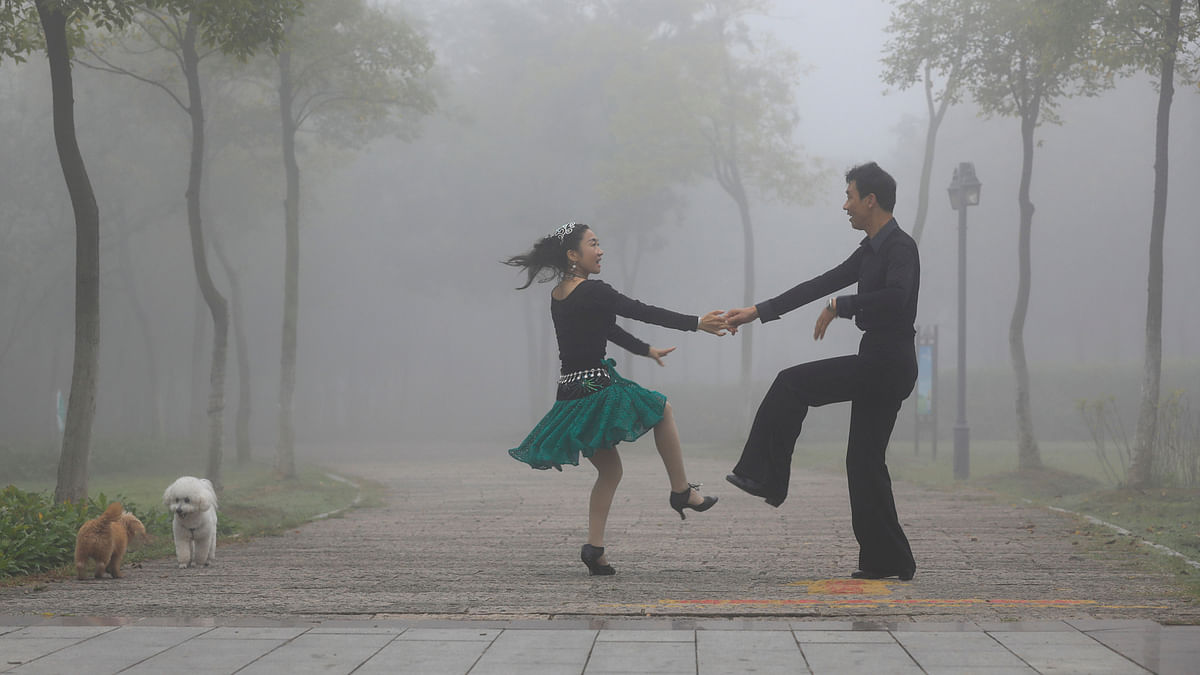 People dance in a park on a foggy day in Huai`an, Jiangsu province, China October 10, 2017. Reuters