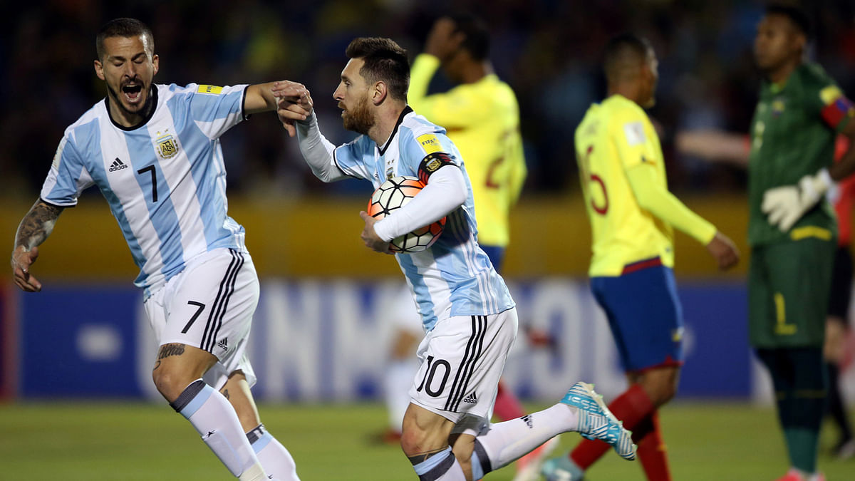 Argentina`s Lionel Messi celebrates with teammate Dario Benedetto after he scored a goal. Reuters