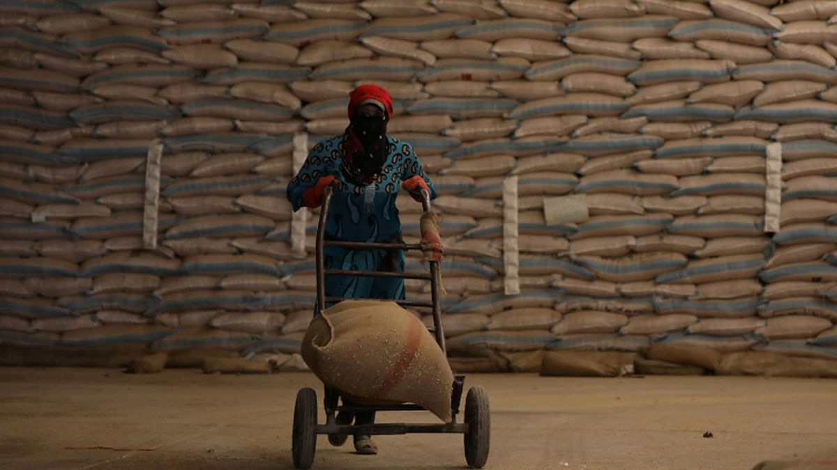A woman pushes a cart loaded with a sack of wheat in Qamishli, Syria, on 18 September 2017. -- Reuters