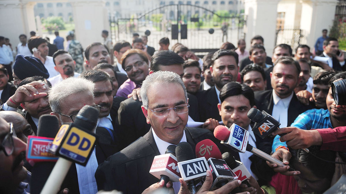 Indian lawyer Tanveer Ahmed Mir (C) leaves Allahabad high court after the acquital of his clients Rajesh and Nupur Talwar over the 2008 double murder of their daughter Aarushi and servant Hemraj Banjade in Allahabad on 12 October, 2017. Photo: AFP