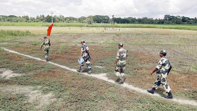 Indian Border Security Force (BSF) soldiers walk across the open border with Bangladesh on 20 June 2015. Reuters File Photo