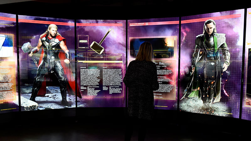 This file photo taken on 13 April, 2016 shows a visitor looks at a display on Marvel Comics superhero `Thor` (L) and character `Loki` at the interactive Marvel Avengers STATION exhibition in the bussines district of La Defense, west of Paris. Photo: AFP