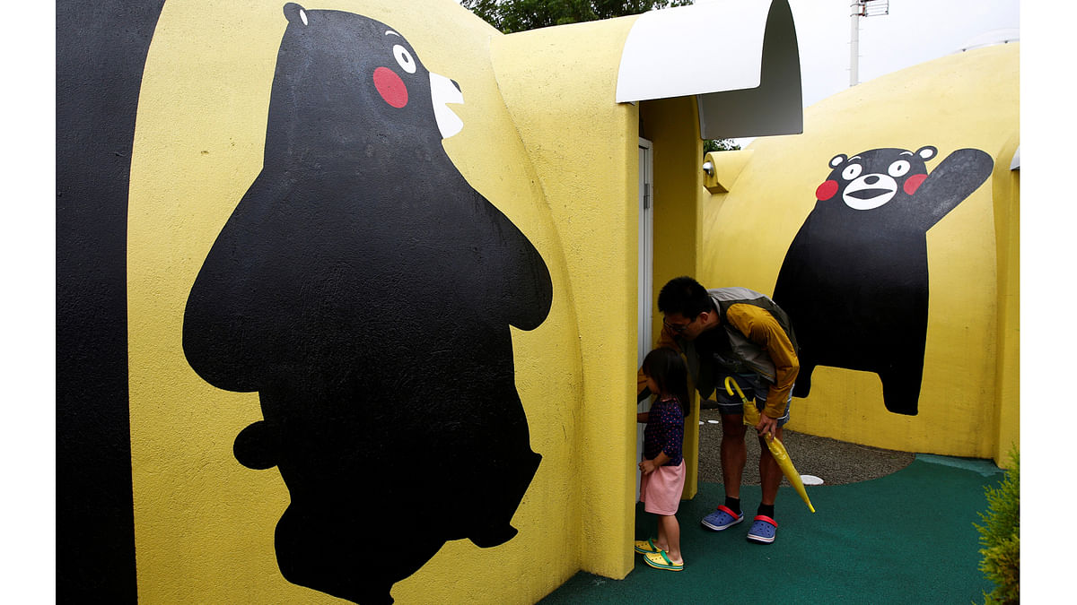 A family from Singapore enters a quake-resistant dome house decorated with Japan`s popular `Kumamon` bear character at the Aso Farm Land resort in Aso, Kumamoto Prefecture, Japan September 15, 2017. Picture taken on September 15, 2017. Reuters