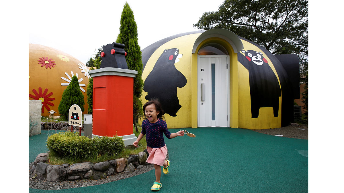 A girl from Singapore runs past a quake-resistant dome house decorated with Japan`s popular `Kumamon` bear character at the Aso Farm Land resort in Aso, Kumamoto Prefecture, Japan September 15, 2017. Picture taken on September 15, 2017. Reuters
