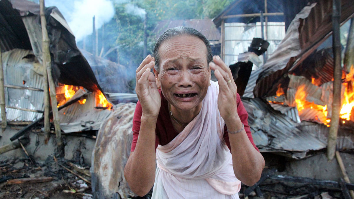 An old woman crying as her house torched at Harkali Thakurpara in Rangpur on Friday. Photo: Moinul Islam