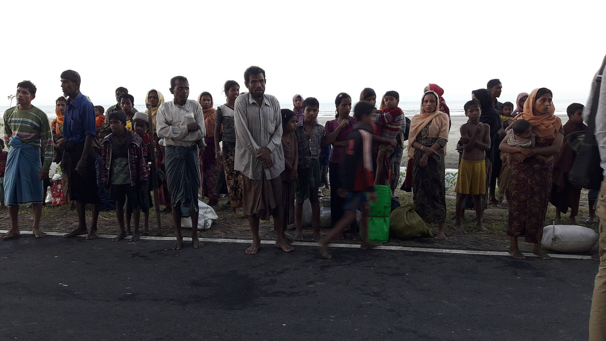 These Rohingyas swim ashore as the boat they hired drop them in chest-deep water in the Bay of Bengal on Friday. Photo: Abu Taib Ahmed