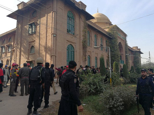 Police and rescue workers stand outside the Directorate of Agriculture Institute in Peshawar. Photo: Reuters