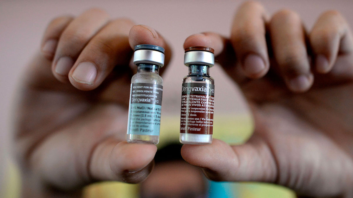 Nurse showing vials of the anti-dengue vaccine Dengvaxia, developed by French medical giant Sanofi, during a vaccination program at an elementary school in suburban Manila. AFP file photo