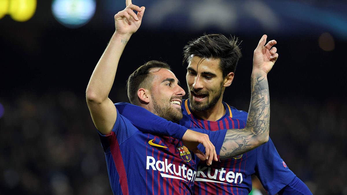 Barcelona’s Spanish forward Paco Alcacer (L) celebrates with Barcelona’s Portuguese midfielder Andre Gomes after scoring a goal during the UEFA Champions League football match FC Barcelona vs Sporting CP at the Camp Nou stadium in Barcelona