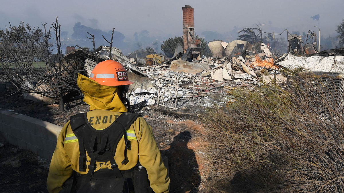 A firefighter looks at a house burnt to the ground during the Thomas wildfire in Ventura, California on Tuesday. Photo: AFP