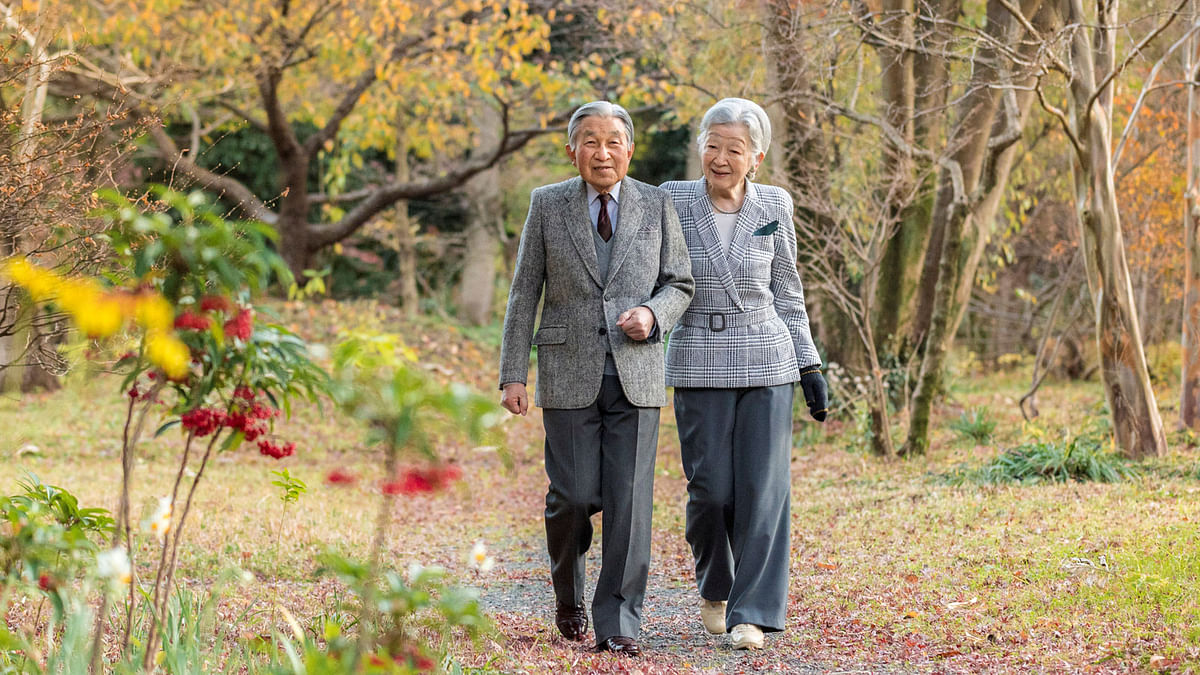 Japan`s Emperor Akihito (L) and Empress Michiko take a stroll in the garden of the Imperial Residence at the Imperial Palace in Tokyo, Japan, in this hand out picture taken on 6 December 2017 and released by the Imperial Household Agency of Japan. Emperor Akihito celebrated his 84th birthday on 23 December 2017. Reuters