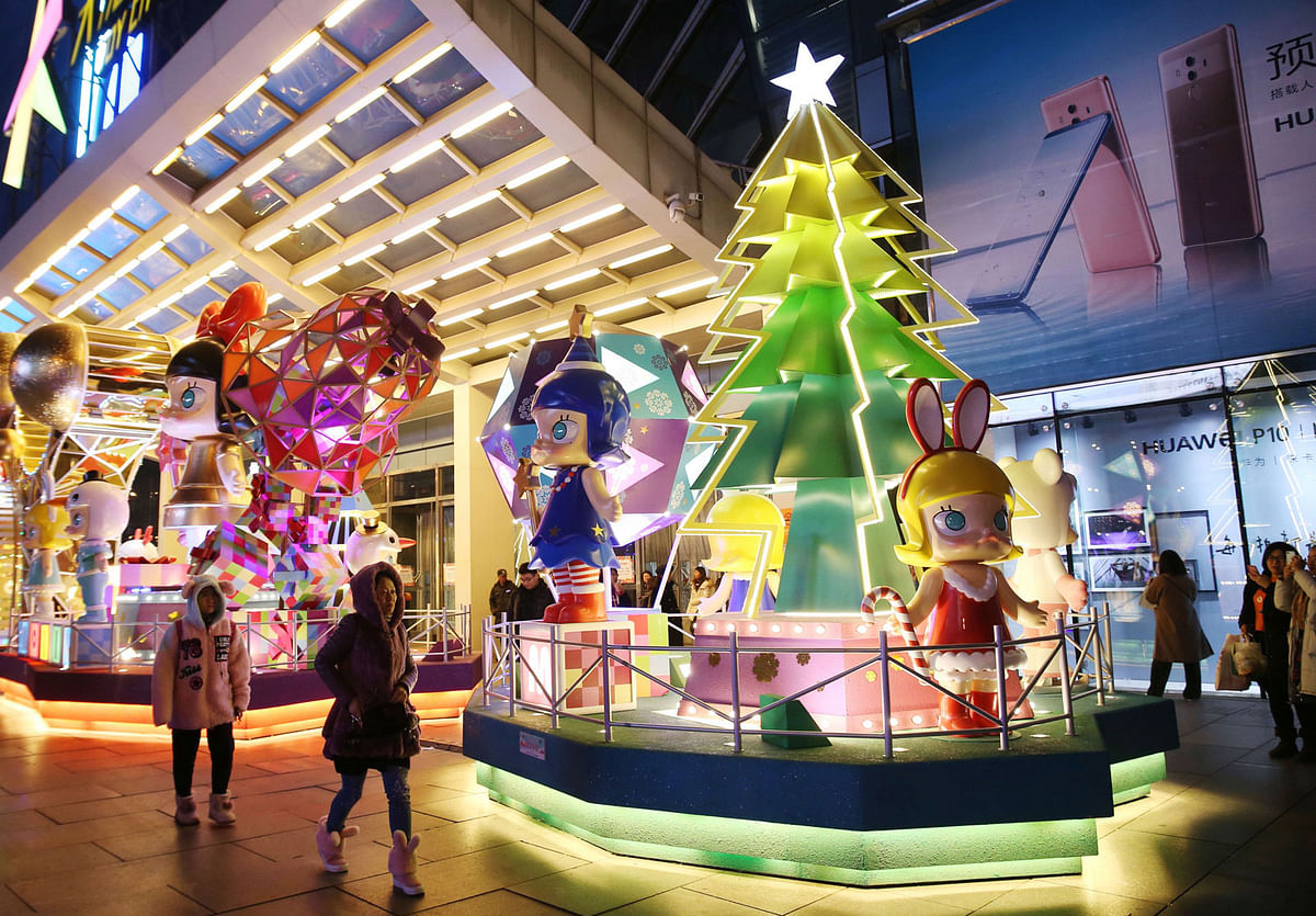 A Christmas decoration is displayed outside a shopping mall in Beijing. China on 18 December. Photo: AFP