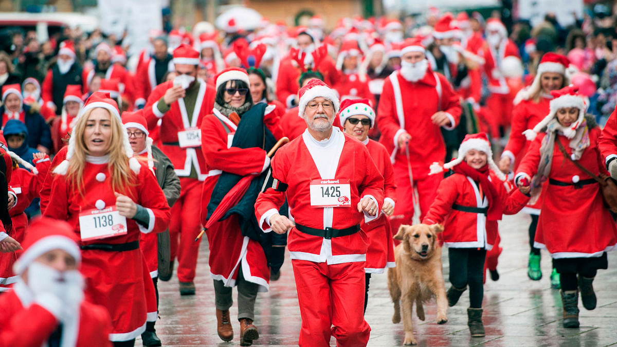 Runners dressed as Santa Claus take part in a charity race to help raise funds for families in need in Kosovo on 17 December.