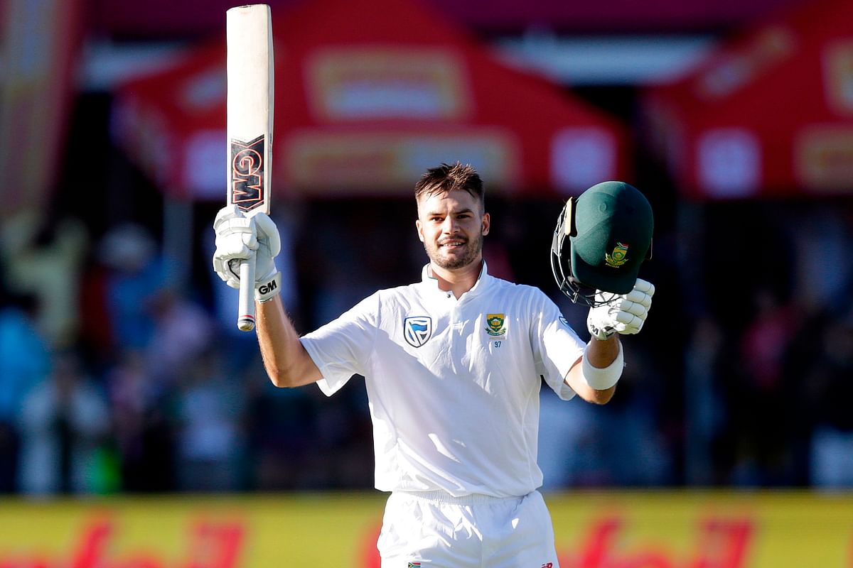 South African batsman Aiden Markram raises his bat and helmet as he celebrates after scoring a century (100 runs) during the first day of the day night Test cricket match between South Africa and Zimbabwe at St George's Park Cricket Ground in Port Elizabeth on 26 December, 2017. Photo: AFP