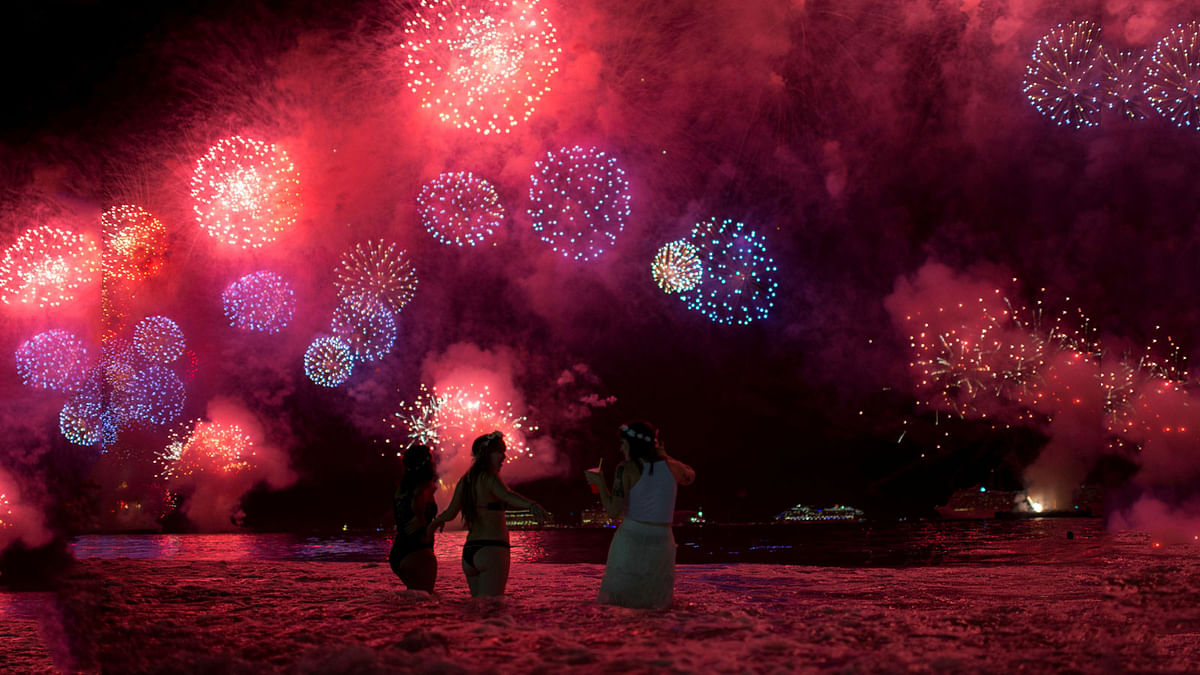 People watch as fireworks explode over Copacabana beach during New Year celebrations in Rio de Janeiro, Brazil on 1 January 2018. Photo: Reuters