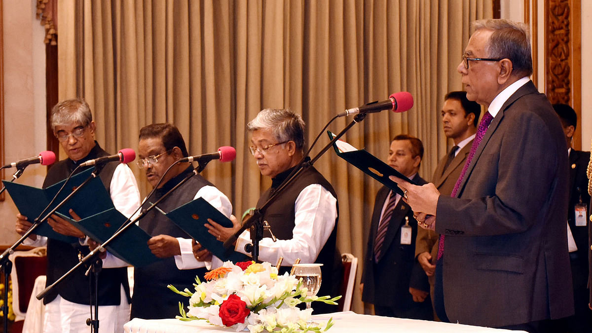 President Md Abdul Hamid administers oath to three ministers - Narayan Chandra Chanda, AKM Shahjahan Kamal, and Mustafa Jabbar - at Bangabhaban on Tuesday. Photo: BSS