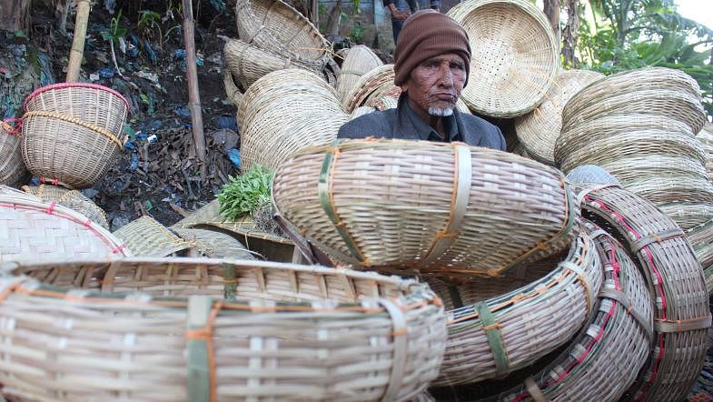 A man sells bamboo baskets. Such baskets are sold at Tk 100-120 each. The photo was taken at Goainghat in Sylhet on 2 January. Photo: Anis Mahmud
