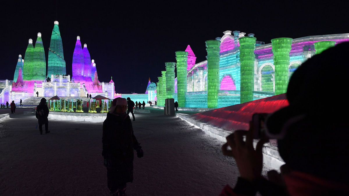 Visitors take photos at the Harbin Ice and Snow World, part of the annual Harbin Ice and Snow Sculpture Festival in Harbin in China`s northeast Heilongjiang province on 4 January 2018. Photo: AFP