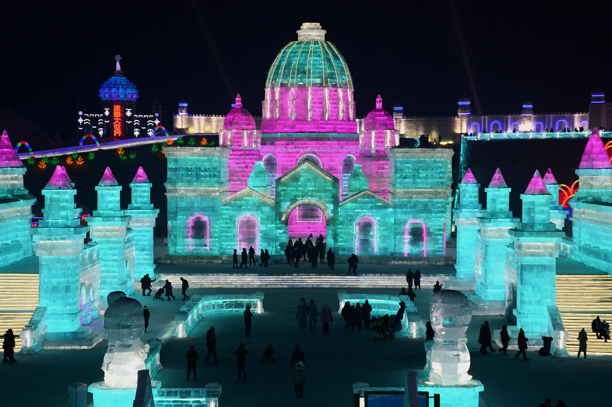 This photo taken on 2 January 2018 shows people visiting the Harbin Ice-Snow World in Harbin in China`s northeastern Heilongjiang province. The city will host on 5 January the Harbin Ice and Snow Sculpture Festival, which attracts hundreds of thousands of visitors annually. Photo: AFP