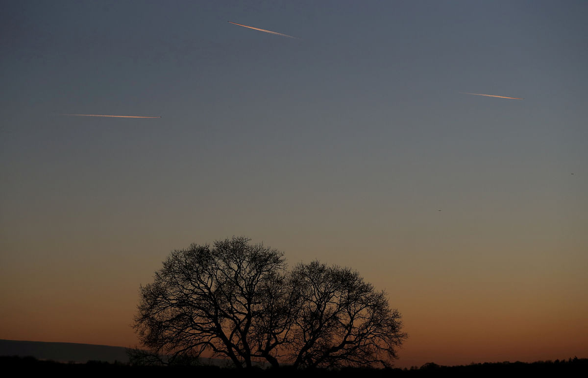 Passenger planes leave behind contrails as they fly in the skies over London Luton Airport, Luton, Britain on 7 January 2018. Photo: Reuters