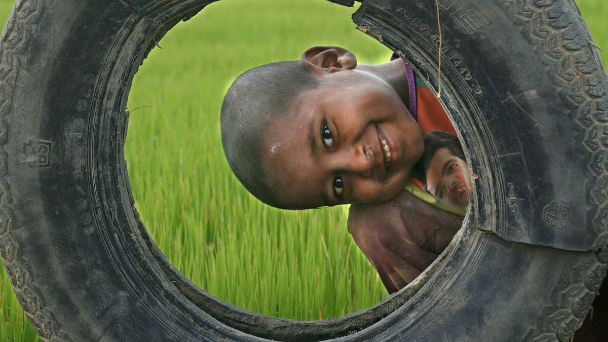 A boy is playing with a rejected tyre at Baishtila area of Sylhet Sadar on 9 January 2018. Photo: Anis Mahmud