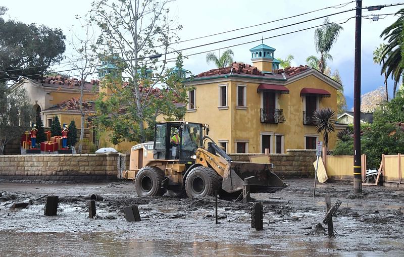 Mud is cleared off a side road off the US 101 freeway near the San Ysidro exit in Montecito, California on Wednesday. Photo: AFP