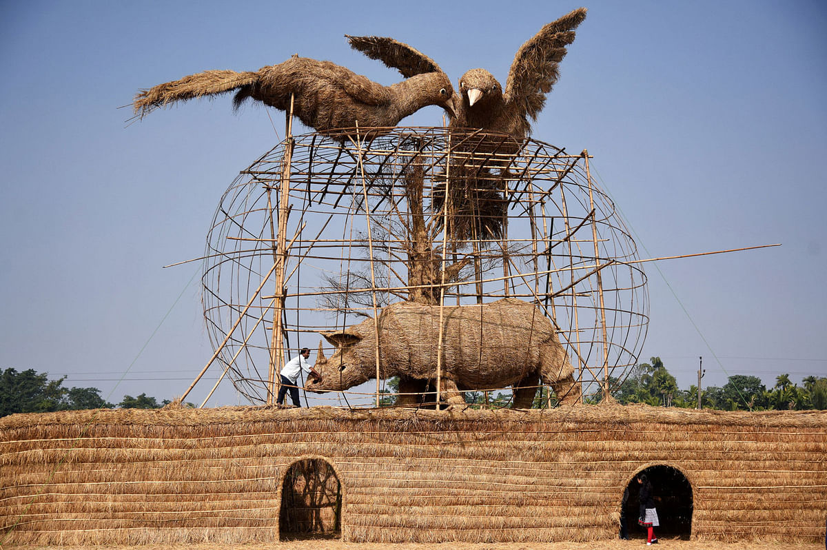 A worker prepares a makeshift cottage called “Bhelaghar”, which is made of bamboo and straw, as part of celebrations ahead of the Magh Bihu festival in Morigaon district, in the northeastern state of Assam, India on 9 January 2018. Photo: Reuters