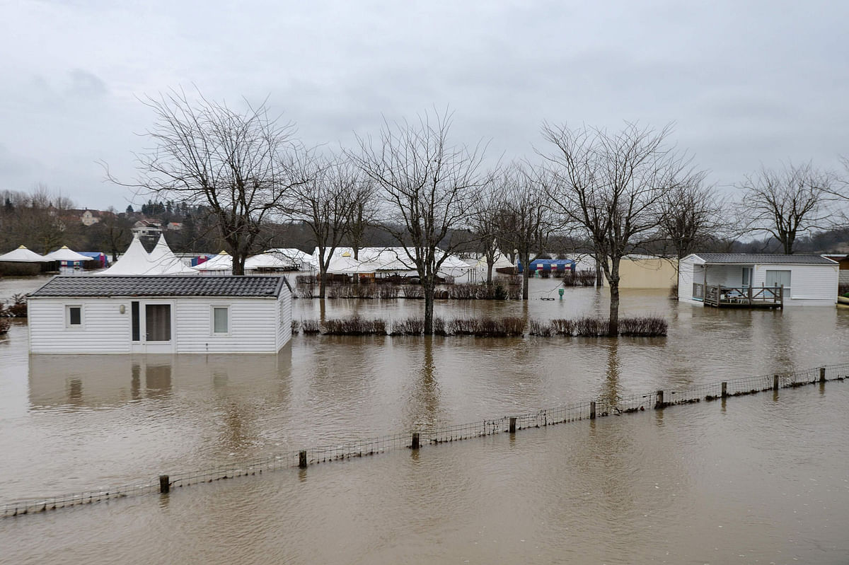 A picture taken on 7 January, 2018 shows buildings in a flooded street in Marnay, after the Ognon river overflowed due to the weather conditions. Photo: AFP