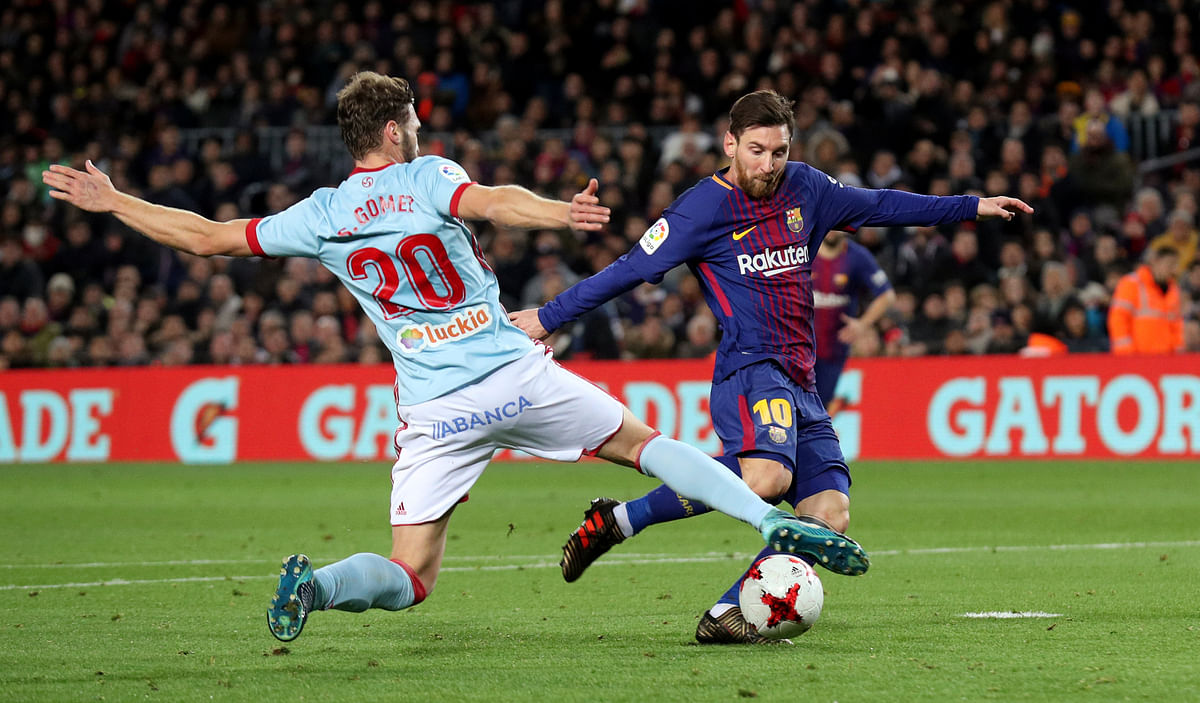 Barcelona’s Lionel Messi in action with Celta Vigo’s Sergi Gomez. REUTERS