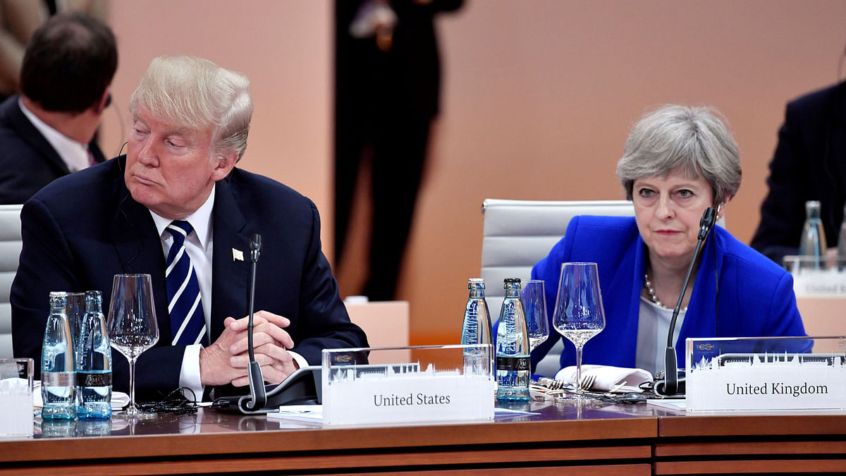 US president Donald Trump and Britain`s prime minister Theresa May wait at the start of the first working session of the G20 meeting in Hamburg, Germany, on 7 July 2017. Reuters File Photo