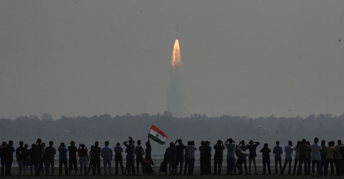 People watch as Indian rocket Polar Satellite Launch Vehicle (PSLV) lifts off successfully from Sriharikota with a record 104 satellites, including the country`s earth observation satellite Cartosat-2 series; at Marina Beach, Chennai on 15 Feb 2017.