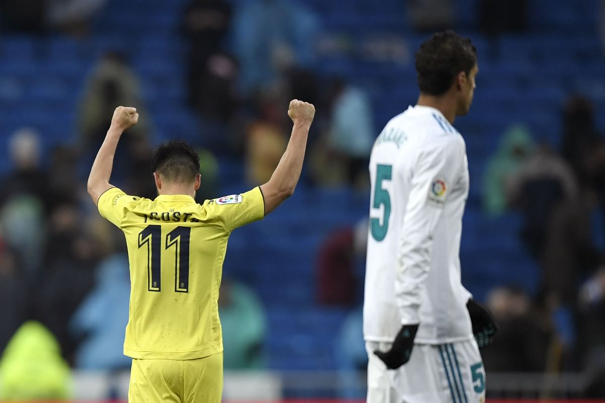 Villarreal's Spanish defender Jaume Costa celebrates next to Real Madrid's French defender Raphael Varane (R) at the end of the Spanish league football match between Real Madrid and Villarreal at the Santiago Bernabeu Stadium in Madrid on 13 January, 2018. Photo: AFP