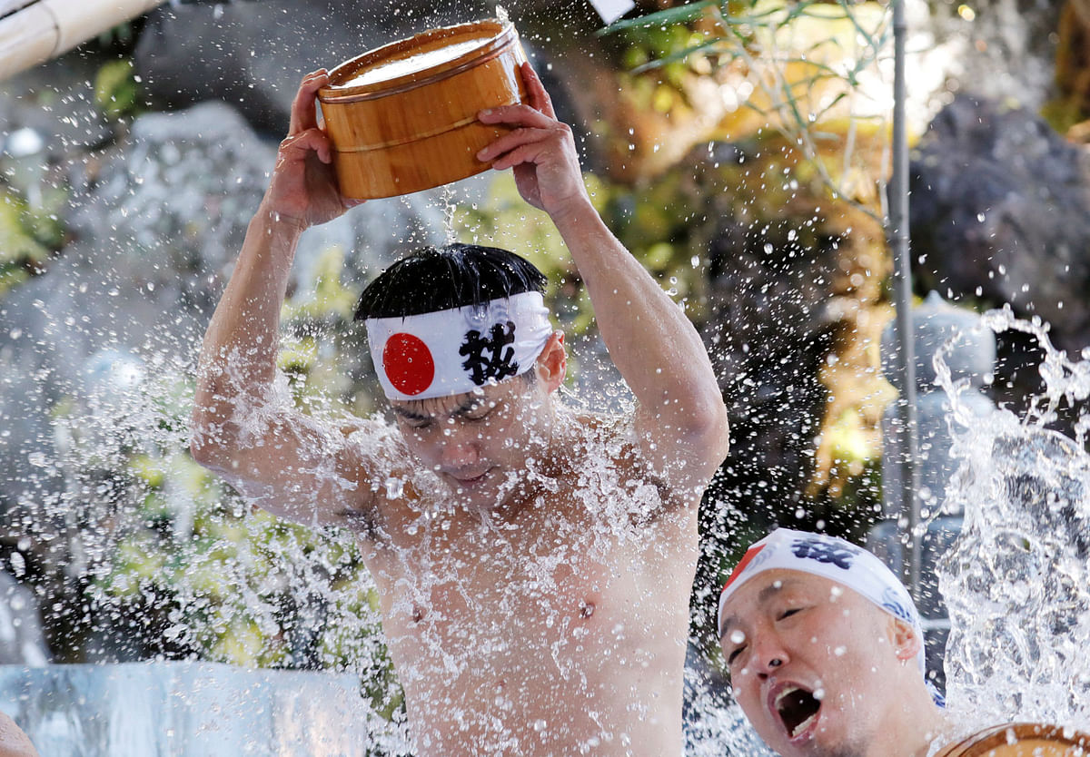 Men splash themselves with cold water during the annual cold water endurance ceremony at the Kanda Myojin shrine in Tokyo, Japan on 13 January. Photo: Reuters