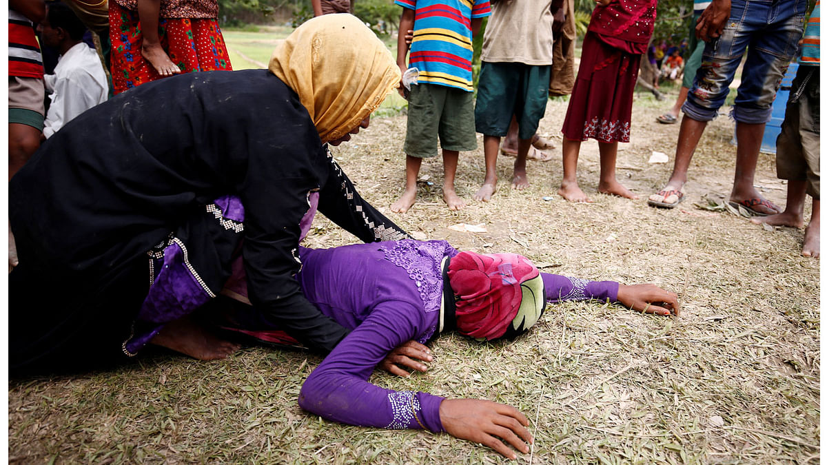 Woman is consoled after receiving news that her husband was killed in Myanmar, in Cox`s Bazar. Photo: Reuters