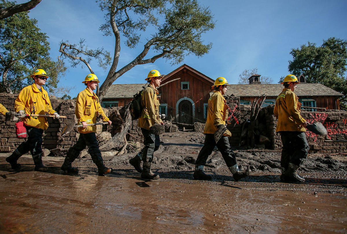 Rescue workers enter properties to look for missing persons after a mudslide in Montecito, California, US on 12 January 2018. Photo: Reuters