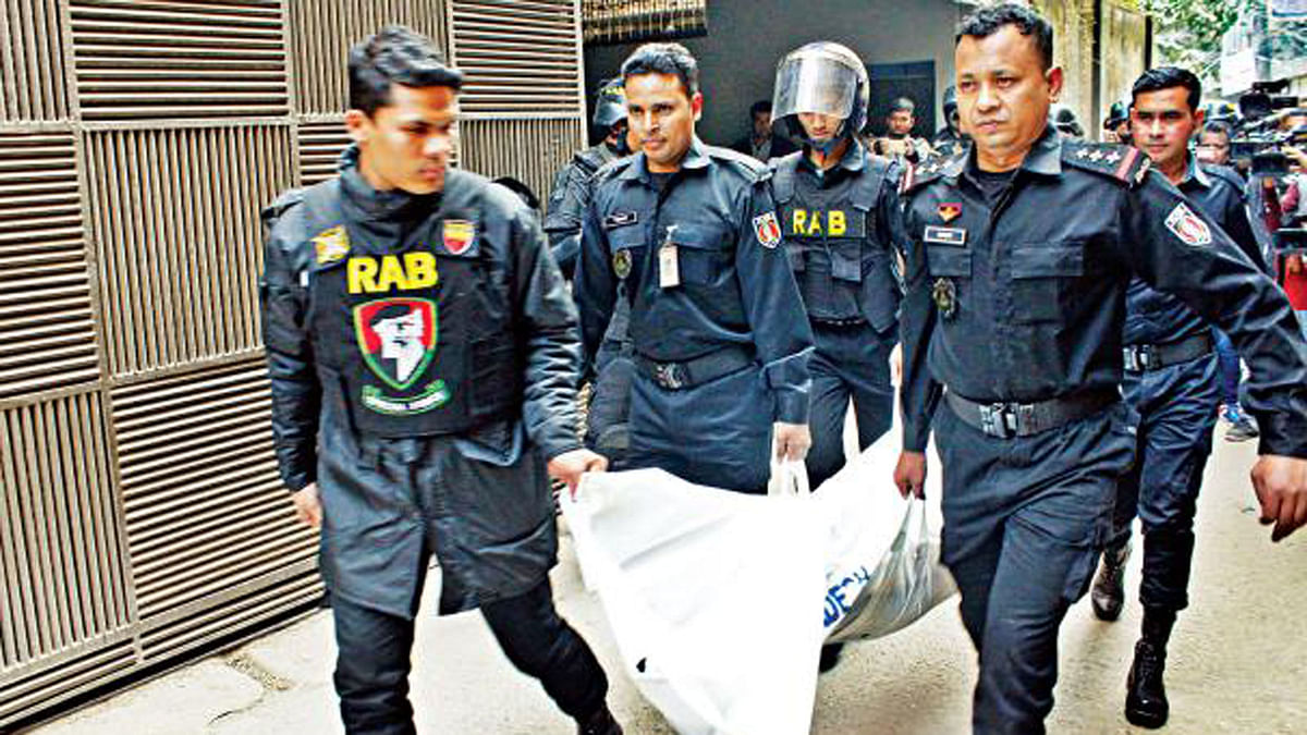 RAB members carrying body of a suspected militants after the Nakhalpara militant hideout raid in Dhaka on Friday. File photo